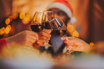 Glasses of champagne and wine in hands of people at party. happy friends or family having christmas...