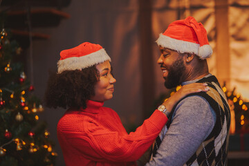 Happy Young affectionate couple African American woman hug husband feel thankful for Christmas...