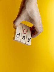 D-Day on yellow background.