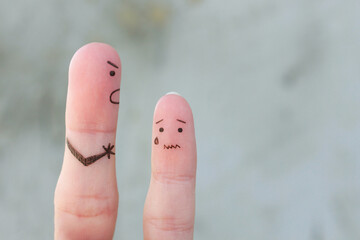 Fingers art of family during quarrel. The concept of father scolded his son, he was crying. - obrazy, fototapety, plakaty