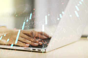 Double exposure of abstract creative financial chart with world map and with hands typing on computer keyboard on background, research and strategy concept