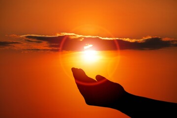 Silhouette of hand on beautiful sky background