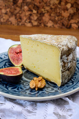 Pieces of cheese tomme de montagne or tomme de savoie made from cow milk in French Alps