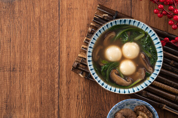 Eating big tangyuan yuanxiao with savory soup in Taiwan.