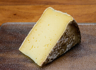Pieces of cheese tomme de montagne or tomme de savoie made from cow milk in French Alps