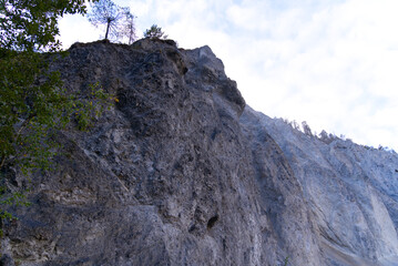 Cliff with cone of debris at canyon of Anterior Rhine Valley on a blue cloudy autumn morning at Versam, Canton Graubünden. Photo taken September 26th, 2022, Versam, Anterior Rhein valley, Switzerland.