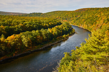 Delaware river in early fall with signs of yellow trees