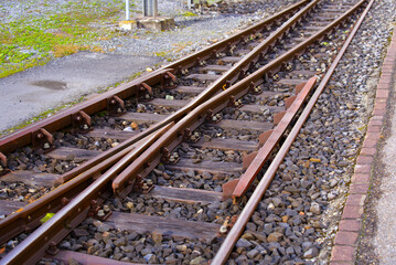 Close-up of railway switch of narrow gauge railway at train station Versam- Safien, Canton Graubünden, on a sunny autumn day. Photo taken September 26th, 2022, Versam, Switzerland.