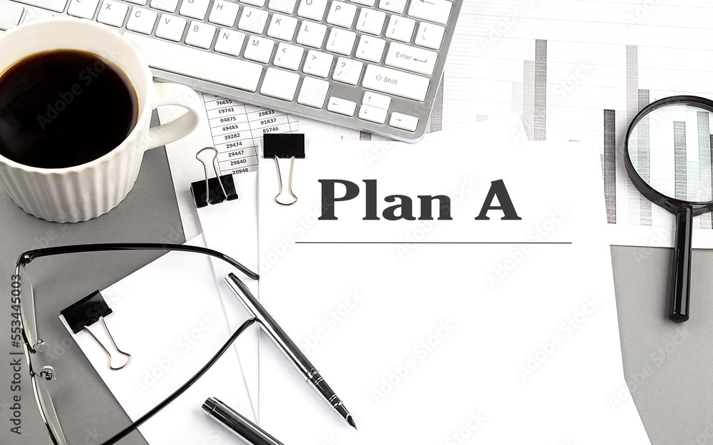 Poster plan a text on a paper with magnifier, coffee and keyboard on grey background