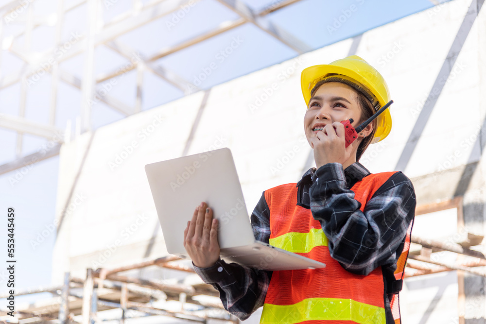 Poster asian engineer architect worker woman working at build construction site use laptop and talking with