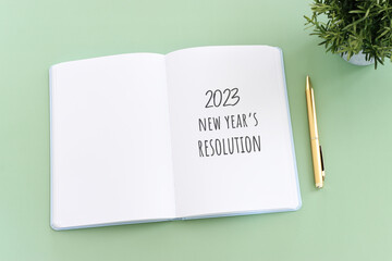 Business concept of top view 2023 new resolution list with notebook over wooden desk