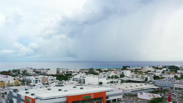 aerial skyline of Playa del Carmen buildings with storm clouds over the ocean