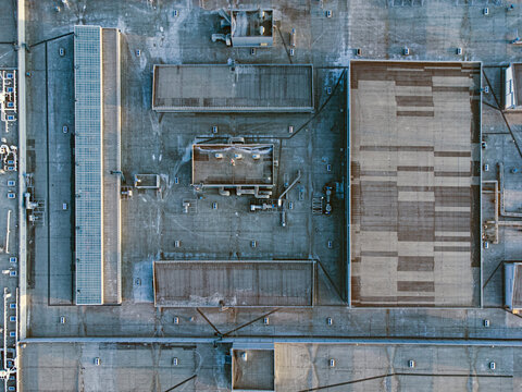 Flat roof of industrial building with engineering equipment.