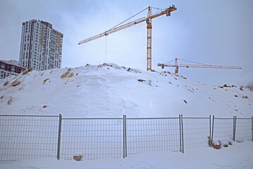 Snow-covered construction site on a winter day
