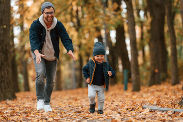 Adventure time. Father and young son is together outdoors at daytime