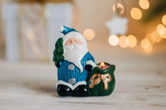 Christmas santa toy decoration closeup image with free copy space for text and festive garland lights