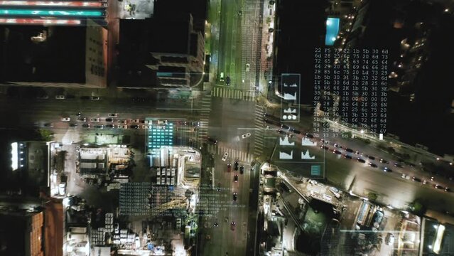 Top down ascending footage of busy road intersection in urban borough. Night hyperlapse shot. Computer added visual effects