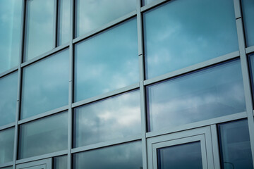 Clouds reflecting in the facade of a modern building