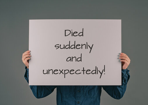 Died suddenly and unexpectedly, young man holds sign, clarification of the increase of mortality, death rate covid-19 jab