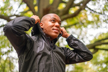Man wearing rain jacket in forest