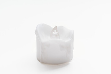 a small electronic candle on a white background. 