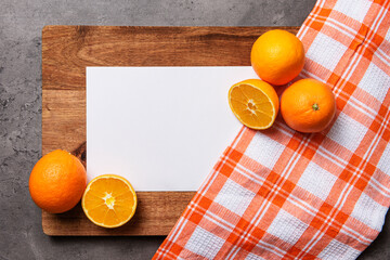 white paper with oranges checkered cloth on wood