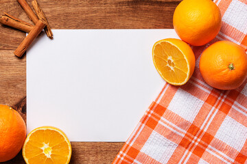white paper cinnamon oranges checkered cloth on wood