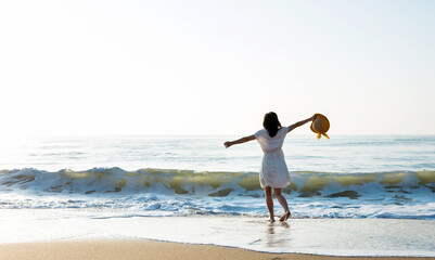 Young woman having fun walking on seaside.