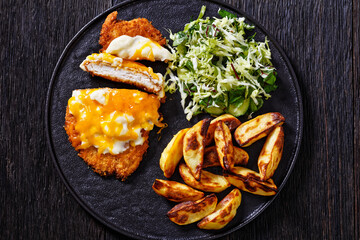 chicken parmo with coleslaw and roast potatoes