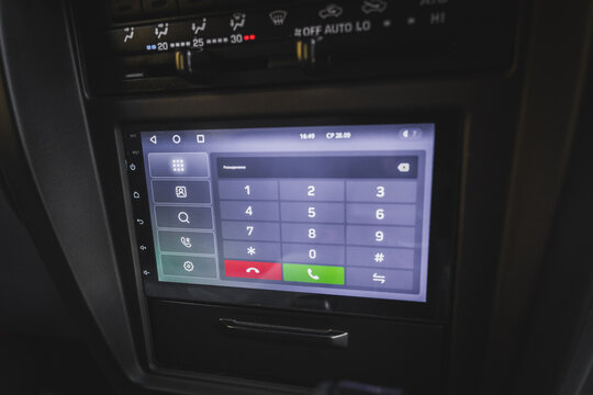 Screen on the center console of the car with telephone dialing.