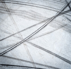 Textured background of vehicle traces on road from scooter, bike, bicycle weel. Tire print texture...
