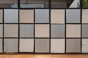 The sliding door is designed by alternating square-shaped galvanized sheets.