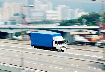 Container truck motion blur on highway overpass