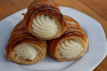 Christmas cookies in shape of a candy cane on a plate on red tablecloth 