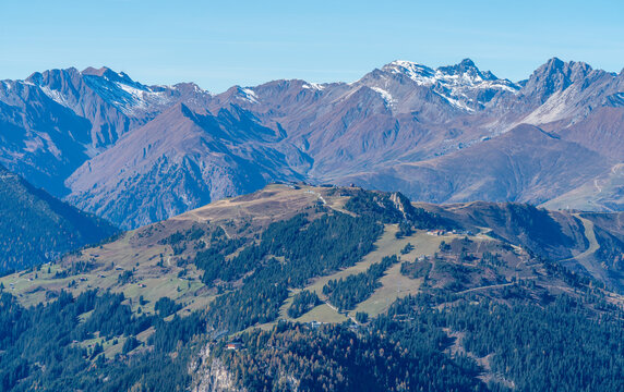Snow covered summit of Lizumer Reckner in the background with the ridge of Penken in the front. Beautiful autumn day in Austrian Alps. Dramatic Alpine mountains scenery under blue sky. Ski resorts.