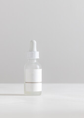 white bottle with dropper of liquid serum cosmetics skincare