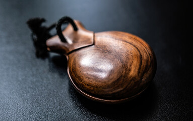 Wooden castanet for flamenco dance closeup. Traditional hispanic musical instrument for live perfomance - obrazy, fototapety, plakaty