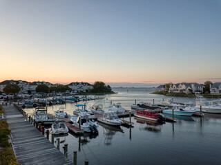 Sunrise over a marina with Ocean City, Maryland off in the distance.