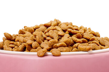 Dry pet food grain-free formula in a white plate and a pink silicone stand. Food for animals isolate