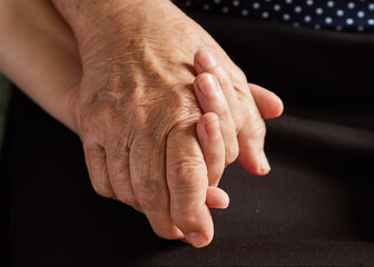 Close-up of young and old hand together.