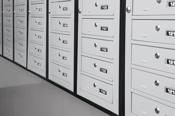 Closed metal mailboxes with keyholes and sequence numbers indoors