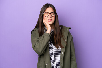 Young Brazilian woman isolated on purple background with toothache