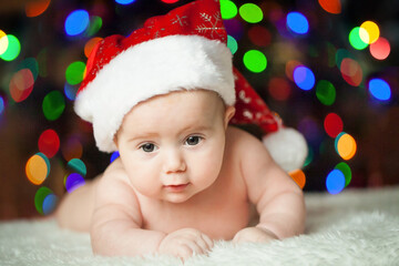 Obraz na płótnie Canvas Cute adorable child in a Santa hat