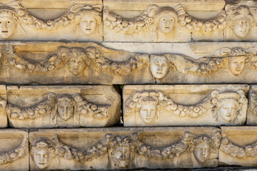 Friezes and sculpted greek masks of the Portico of Tiberius in Aphrodisias ancient city. Ruins of...