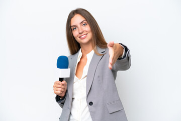 Young TV presenter caucasian woman isolated on white background shaking hands for closing a good...
