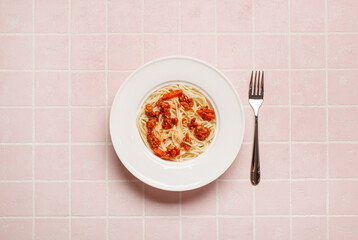 top view of pasta with meat near  fork on pink background