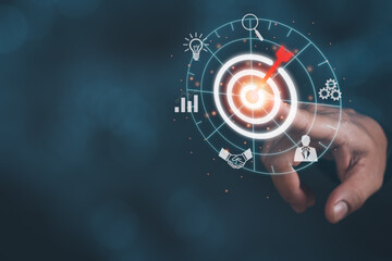 man finger touching dart board icon with red arrow, showing concept success targeting, strategy, planning ,development for business goals do it efficiently,bokeh background