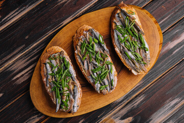 Top view pickled anchovies with spring onions