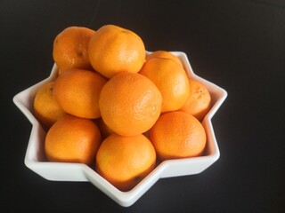 tangerines in star shaped bowl