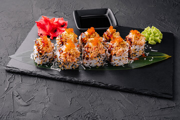 Japanese sushi volcano roll with eel on top and sesame inside